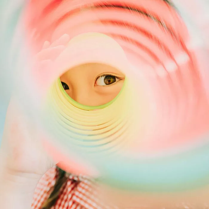 Close-up of a pupil's eye through a slinky toy